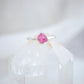 Close up of the details on the raw, rough surface of the Pink Tourmaline ring. The band is sterling silver and the stone is prong set.