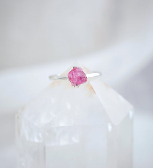 Close up of the details on the raw, rough surface of the Pink Tourmaline ring. The band is sterling silver and the stone is prong set.