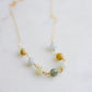 A multi-color burma jade necklace featuring seven round green, brown, yellow, or blue natural stones. Handmade in Connecticut by Gemnia Jewelry.