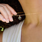 Black Onyx gold heart necklace. A black stone heart bezeled in gold is suspended from a 14k gold filled chain.