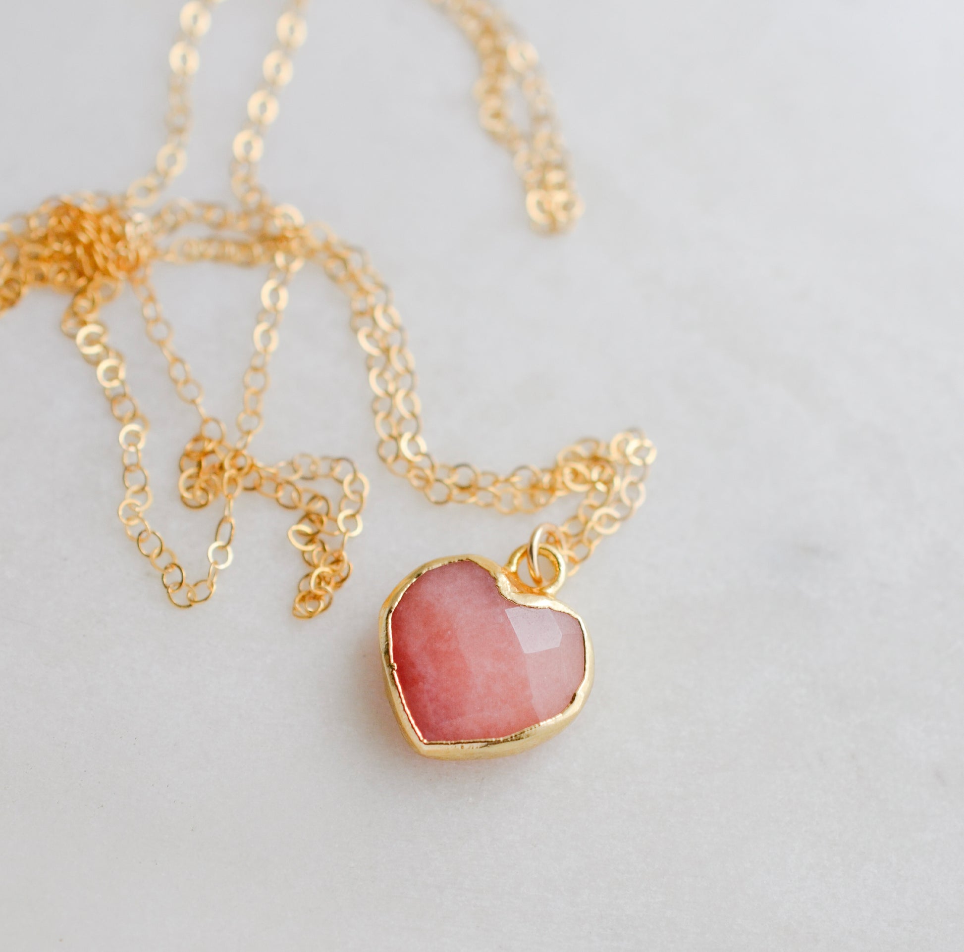 Handmade necklace with a natural pink opal heart-shaped pendant on a 14k gold filled chain. Handcrafted dainty gemstone jewelry by Gemnia.