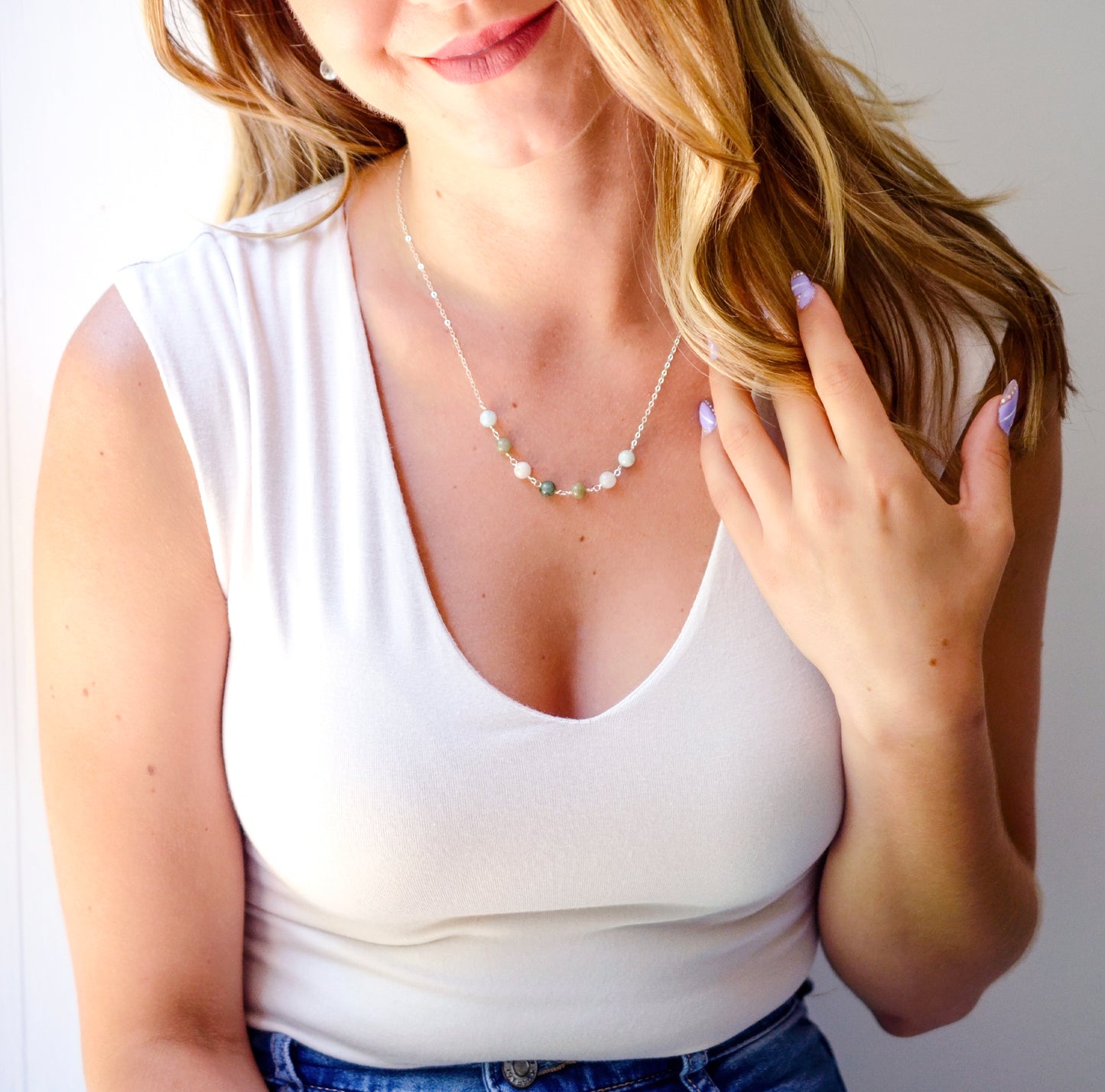 Modeled image in a sterling silver style. A multi-color minimalist genuine jade necklace featuring seven round green, brown, yellow, or blue natural stones. Handmade in New England by Gemnia Jewelry.