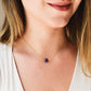 Small blue sapphire stone set onto a gold chain. The stone is a puffed oval shape. Modeled image.