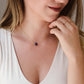 Small blue sapphire stone set onto a gold chain. The stone is a puffed oval shape. Modeled image.