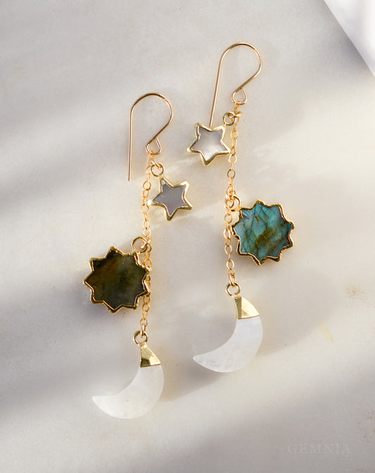 Pair of handmade earrings with star, moon, and turquoise stone designs in 14k gold filled. Handmade in Connecticut by Gemnia.