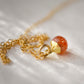 Natural orange Sunstone necklace. The stone is a faceted round and set onto a 14k gold filled chain.