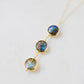 Necklace with three faceted genuine Labradorite stones on a 14k gold filled chain. This handcrafted artisan necklace is also available in sterling silver. Made in New England by Gemnia Jewelry.