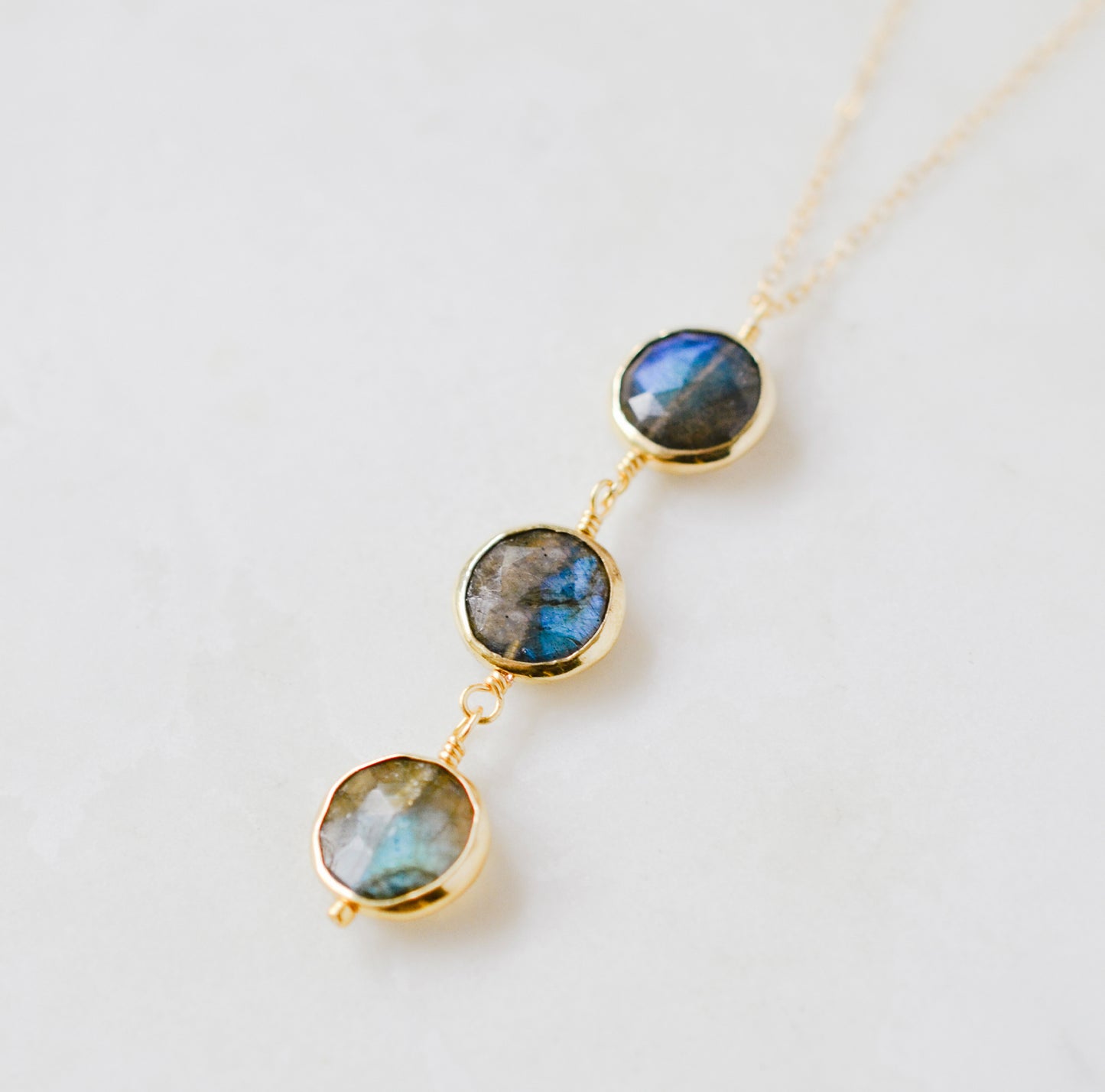 Necklace with three faceted genuine Labradorite stones on a 14k gold filled chain. This handcrafted artisan necklace is also available in sterling silver. Made in New England by Gemnia Jewelry.