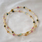 Multicolored, smooth polished Tourmaline gems hand-beaded with gold plated glass beads. Colors range from pink, green, brown, yellow, or black.