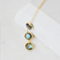 A delicate necklace with three natural labradorite stones on a 14k gold filled chain. This necklace is handmade in Connecticut by Gemnia Jewelry.