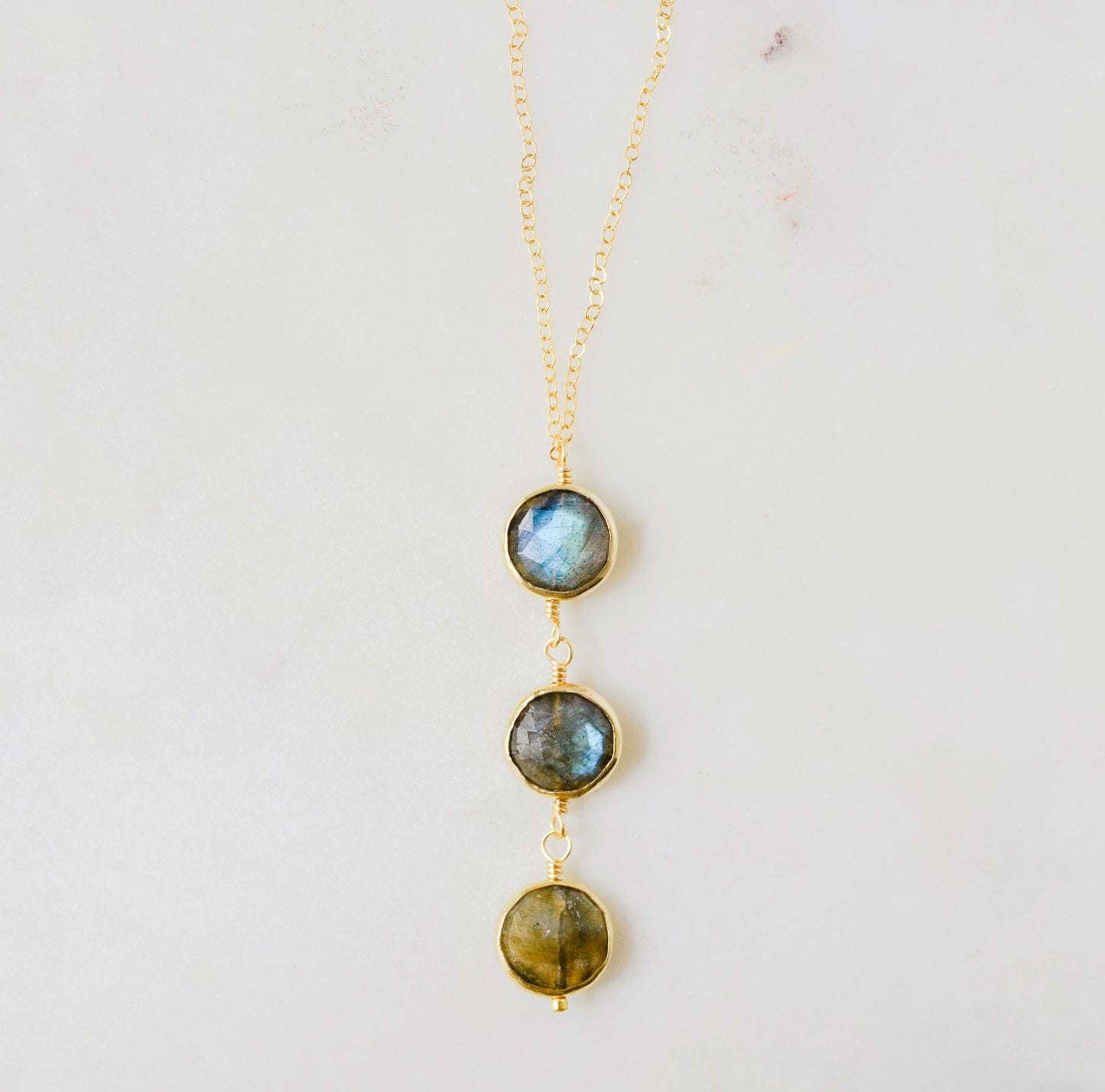 A handmade necklace with three natural Labradorite stones on a 14k gold filled chain.
