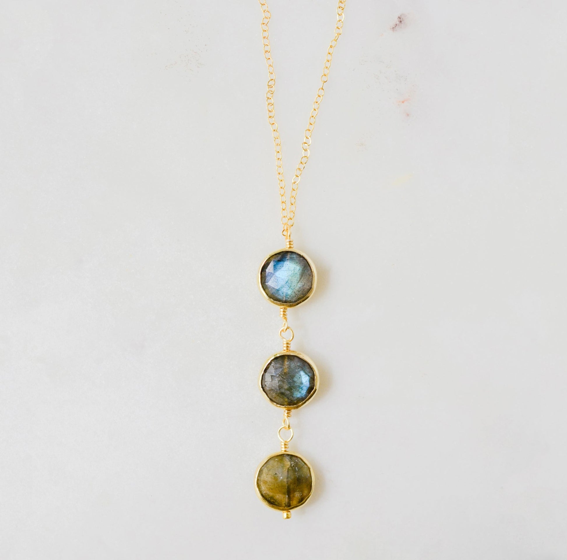 A handmade necklace with three natural Labradorite stones on a 14k gold filled chain.