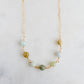 A multi-color natural real jade necklace featuring seven round green, brown, yellow, or blue natural stones. Handmade in Connecticut by Gemnia Jewelry.
