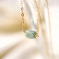 Pale green raw jade stone set onto a 14k gold filled chain. 