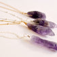 Raw purple amethyst crystals set onto chains. 