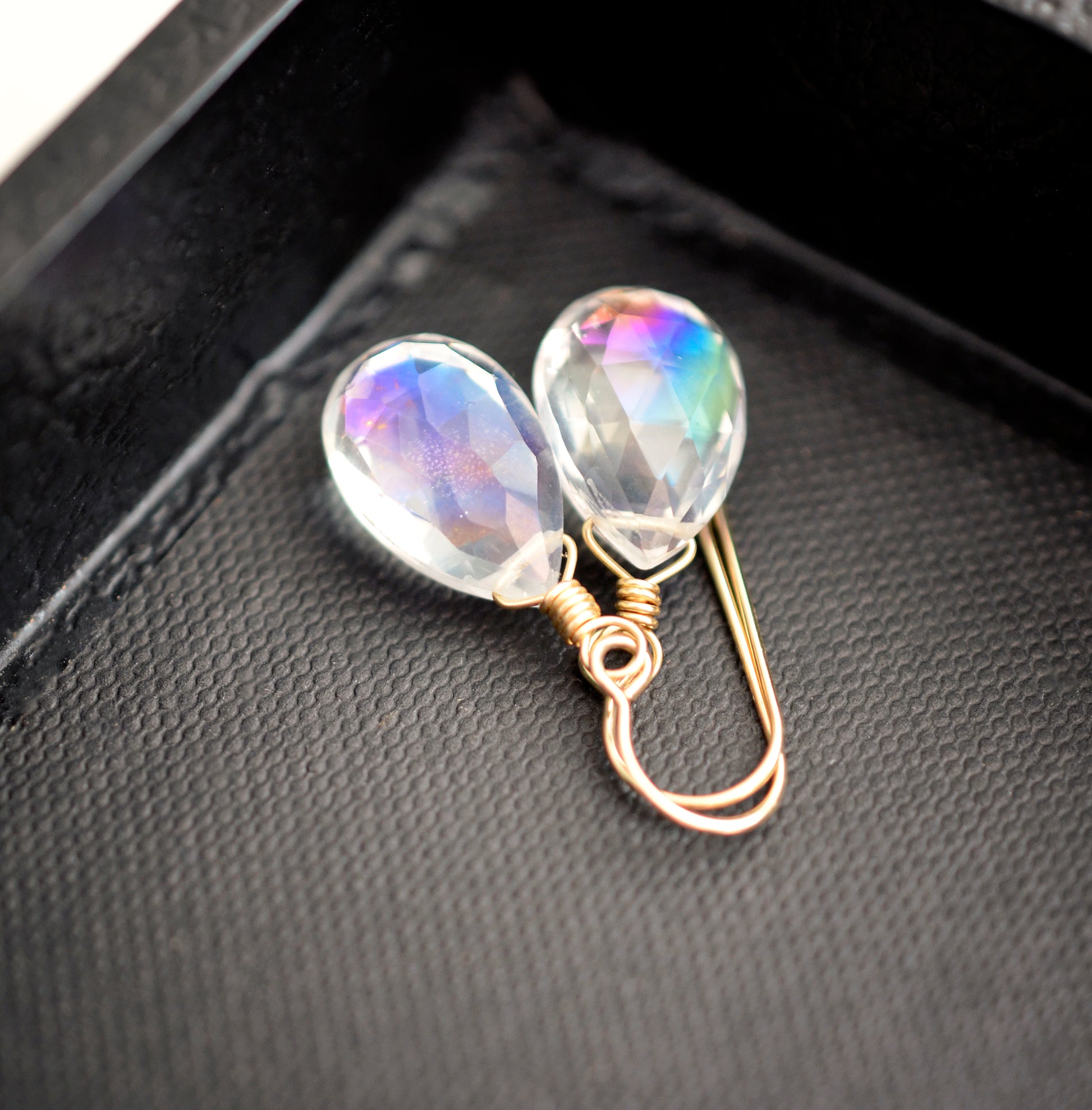 Rainbow colored mystic topaz earrings in 14k gold filled. The stone is a teardrop shape and shifts different rainbow colors..