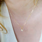 Rainbow Quartz teardrop crystal on a gold filled chain. The stone flashes a shimmering array of rainbow colors. Modeled image.
