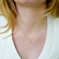 Rainbow Quartz teardrop crystal on a gold filled chain. The stone flashes a shimmering array of rainbow colors. Modeled image.