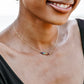 Modeled image. Handmade real gemstone chakra necklace. Stones include: garnet, carnelian, CZ, peridot, turquoise, lapis lazuli, and amethyst.