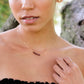 Dainty red garnet bar necklace in gold.