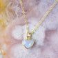 Natural rainbow moonstone heart pendant set onto a sterling silver or gold filled chain. Small stone heart pendant. 