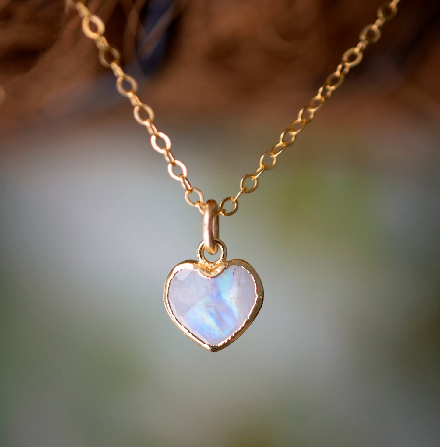 Natural rainbow moonstone heart pendant set onto a sterling silver or gold filled chain. Small stone heart pendant. 