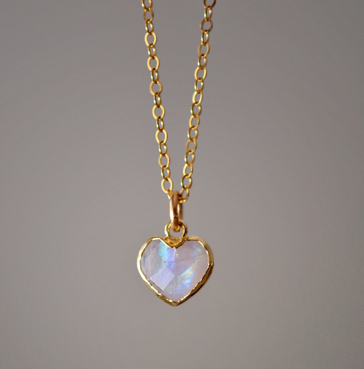 Natural rainbow moonstone heart pendant set onto a sterling silver or gold filled chain. Small stone heart pendant. 