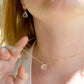 Close up of the rainbow colors in the Mystic Topaz crystal. The 14k gold filled style is shown. Modeled with matching earrings.