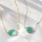 Aqua blue amazonite slice gemstone set onto a 14k gold filled chain. The stone is semi oval in shape, but irregular. It's smooth polished, but with raw edges. Both the silver and gold style are shown.