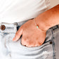 Pale green raw jade stone set onto a 14k gold filled chain. Modeled image.